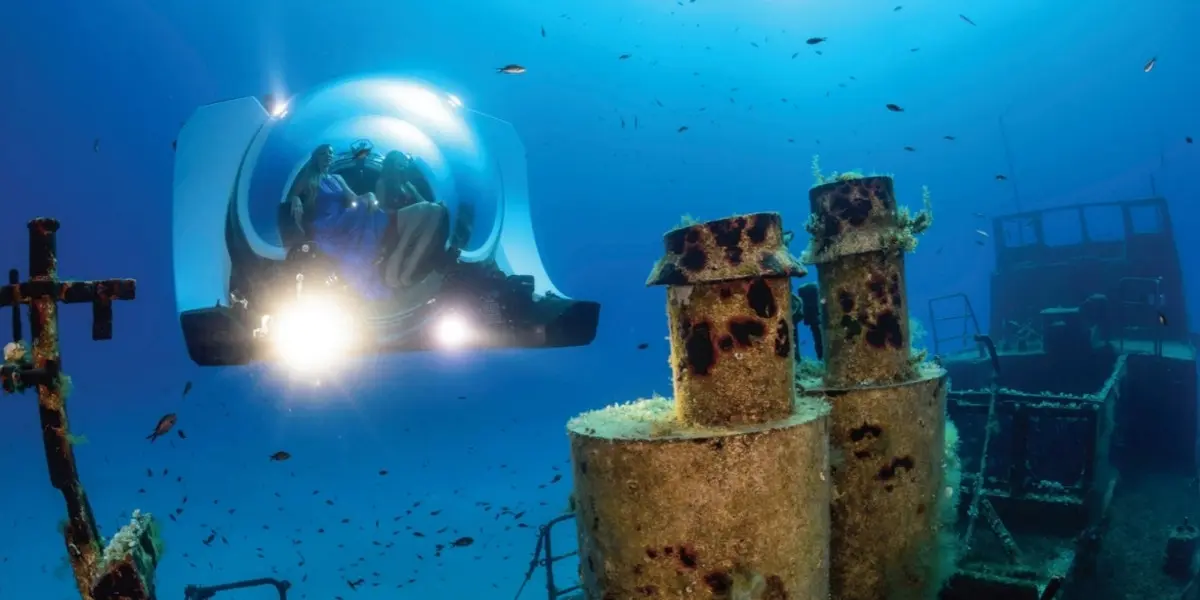 Divers in a submersible, exploring a sunken ship